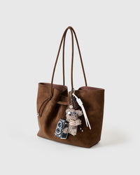 POODLEGRAM plush poodle and mini-camera charm clipped to a handbag, by STICKYZOO