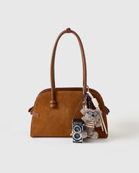 POODLEGRAM plush poodle and mini-camera charm clipped to a handbag, by STICKYZOO
