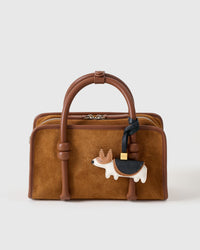Every panel of the corgi charm is cut by hand and stitched through real French leather. Layered slowly for depth — no prints, no stamps.