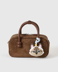 Point-Color Ragdoll charm styled on a bag — a small, specific piece that turns a simple bag into a personal one.