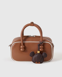 BEAR CHARM charm styled on a bag — a small, specific piece that turns a simple bag into a personal one.