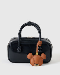 BEAR CHARM charm styled on a bag — a small, specific piece that turns a simple bag into a personal one.