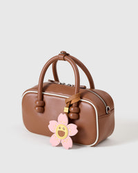 STICKYZOO Bloomy Sakura Charm in soft pink and golden yellow — handmade French Alran goatskin, hand-cut and hand-stitched over 3 days.
