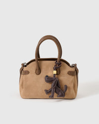 Close-up of handmade Basset Hound leather bag charm — heavy contrast saddle-style hand stitching on every edge, full-grain French Alran goatskin. STICKYZOO.