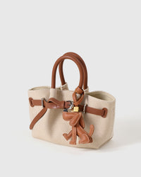 Handmade Basset Hound leather bag charm — slow craft in French Alran goatskin. STICKYZOO Amsterdam design.