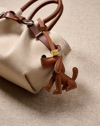 Handmade Basset Hound leather bag charm with 18K gold-plated cube hardware engraved with STICKYZOO — French Alran goatskin, 3-day artisan build.
