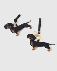 Long Dash Dachshund bag charm shown in both attachment options — handmade French Alran goatskin, dual attachment for bags or keys. STICKYZOO Amsterdam design.