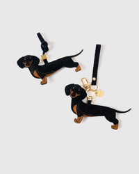 Handmade full-body Dachshund bag charm clipped to a handbag — French Alran goatskin, 5-day artisan build. STICKYZOO Long Dash.