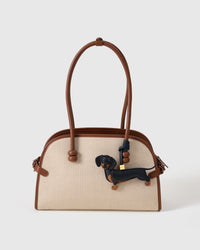 Handmade full-body Dachshund bag charm — hand-layered black coat with tan paws and snout in French Alran goatskin. STICKYZOO Long Dash.