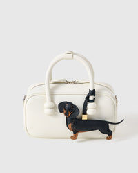 Close-up of handmade Dachshund bag charm — hand-cut tan paw panels and curled tail in French Alran goatskin, hand-stitched throughout. STICKYZOO Long Dash.