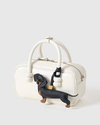 Handmade full-body Dachshund bag charm styled on a handbag — French Alran goatskin, 18K gold-plated hardware. STICKYZOO Long Dash.