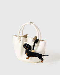 Long Dash Dachshund bag charm in both attachment formats — leather strap with engraved 18K gold cube and 18K gold-plated keychain clip. Handmade French Alran goatskin.