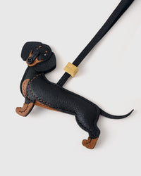 Handmade full-body Dachshund bag charm on a handbag — built to last from French Alran goatskin, hand-layered, hand-stitched. STICKYZOO Long Dash.