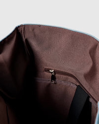 STICKYZOO Dachshund Backpack interior showing brown cotton lining, internal zip pocket, and laptop sleeve strap