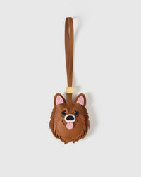 Chocolate Pomeranian charm handmade from French Alran genuine goatskin and French suede — real full-grain leather from Tarn, since 1903. 3 days of hand-cutting, hand-stitching, hand-layering. Arrives in luxury gift packaging. Designed in Amsterdam.