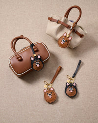 Every panel of the chocolate pomeranian charm is cut by hand and stitched through real French leather. Layered slowly for depth — no prints, no stamps.