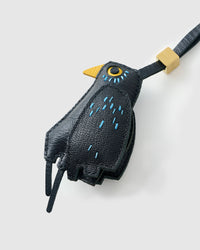 Blackbird charm on a bag, side angle — loved by thousands of bird lovers. Real French leather, 3 days by hand.