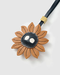 STICKYZOO Sunflower Mood Charm in caramel with dark character centre French Alran goatskin. Hand-cut, hand-stitched. Designed in Amsterdam.