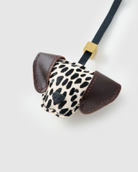 Handmade Dalmatian Spot leather bag charm styled on a handbag — French Alran goatskin, 18K gold-plated hardware. STICKYZOO.