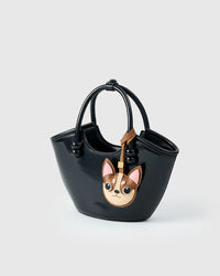 Handmade Chihuahua leather bag charm clipped to a handbag — French Alran goatskin, 5-day artisan build. STICKYZOO.