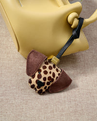 Close-up of handmade Dalmatian Spot leather bag charm — hand-layered leather ears in French Alran goatskin, hand-stitched edges. STICKYZOO.