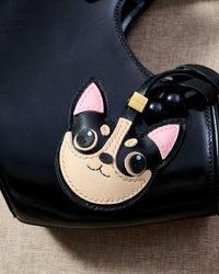 Handmade Chihuahua leather bag charm on a handbag — 3 days of hand-cutting, stitching, and layering in French Alran goatskin. STICKYZOO.