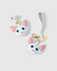 Snow-white Devon Rex cat charm styled on a bag — real French leather, 3 days by hand.