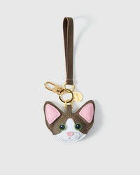 Devon Rex cat charm — close-up of the hand-cut face details, pink inner ears, real-leather eyes. Every panel by hand through real French leather.