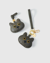 Both editions of the Blue British Shorthair side by side — leather strap loop for bags, or 18K gold-plated keychain clip.