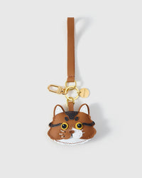 Black long-hair tabby cat charm — black body, warm brown forehead stripes, bright gold-yellow eyes, white chin, real fiber whiskers, black leather strap. Hand-cut from real French Alran goatskin over three days.