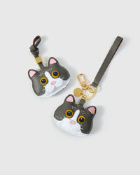 Both Grey Mist editions of the British Shorthair side by side — leather strap loop for bags, or 18K gold-plated keychain clip.
