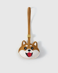 Shiba Inu Face charm handmade from French Alran genuine goatskin and French suede — real full-grain leather from Tarn, since 1903. 3 days of hand-cutting, hand-stitching, hand-layering. Arrives in luxury gift packaging. Designed in Amsterdam.