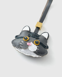 Gray-and-white long-hair tabby on an 18K gold-plated keychain clip with engraved STICKYZOO disc — clips to keys, bags or backpacks.