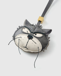 Tight close-up of the Grump cat face, angled — gold-orange eyes in real leather, dark masked markings, real fiber whiskers. Every panel by hand.