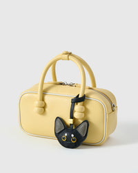 All-black Devon Rex with grey ears in strap and keychain editions — real French leather, finished one at a time by hand.