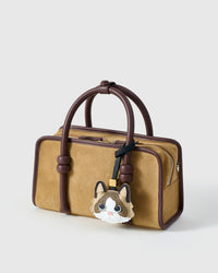 Ragdoll v.1 on a tan suede top-handle bag, side angle — 5,000+ reviews across STICKYZOO. Real French leather, 3 days by hand.