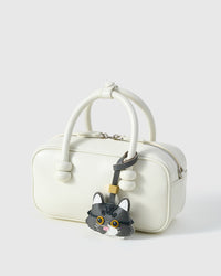 Gray-and-white long-hair tabby on a bag, side angle — rated 4.9★ by thousands of buyers. Real French Alran leather, 3 days by hand.