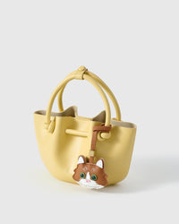 Gray European Shorthair charm — small, specific, French leather. The piece that lives on the bag every day.