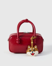 Every panel of the Shiba Inu face charm is cut by hand and stitched through real French leather. Layered slowly for depth — no prints, no stamps.