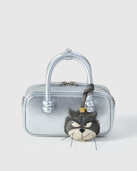 Grump cat charm styled on a metallic silver box bag, front — a small, specific piece that turns a simple bag into a statement.