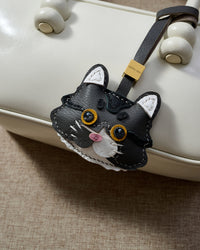 Gray-and-white long-hair tabby — close detail. 5,000+ reviews across STICKYZOO. Real French leather, 3 days by hand.