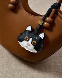 Gray European Shorthair charm — real French leather, made to be carried on the bag that sees every day.
