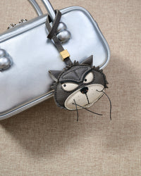 Grump cat charm close on a metallic silver box bag, detail view — real French leather, 3 days by hand.