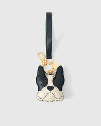 Handmade French Bulldog leather bag charm clipped to a handbag — French Alran goatskin, 3-day artisan build. STICKYZOO.
