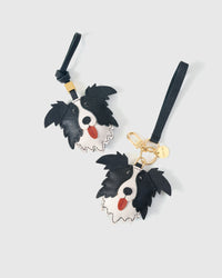 Wear the border collie charm on a bag with the leather strap loop, or clip it to keys with the 18K gold-plated keychain clip.