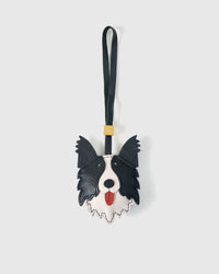 Border Collie charm handmade from French Alran genuine goatskin and French suede — real full-grain leather from Tarn, since 1903. 3 days of hand-cutting, hand-stitching, hand-layering. Arrives in luxury gift packaging. Designed in Amsterdam.