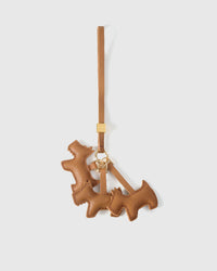 Triple Schnauzer charm handmade from French Alran genuine goatskin and French suede — real full-grain leather from Tarn, since 1903. 3 days of hand-cutting, hand-stitching, hand-layering. Arrives in luxury gift packaging. Designed in Amsterdam.
