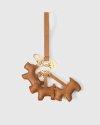 Wear the triple schnauzer charm on a bag with the leather strap loop, or clip it to keys with the 18K gold-plated keychain clip.