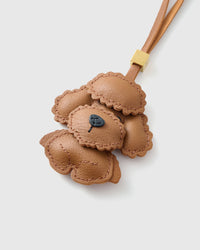 Poodle leather bag charm shown in both attachment options — handmade French Alran goatskin, dual attachment for bags or keys. STICKYZOO Amsterdam design.