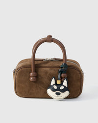 Every panel of the black Tokyo Shiba charm is cut by hand and stitched through real French leather. Layered slowly for depth — no prints, no stamps.